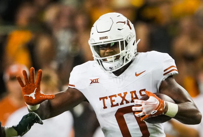 Texas tight end Ja'Tavion Sanders (0) carries the ball as Baylor safety Devin Lemear (20) chases during the third quarter of the Longhorns' game against the Baylor Bears